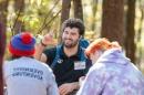 Mason Burke speaks with a group of youth at a recent outdoor adventure in Durham, N.H.