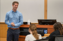 Steve Irlbeck in front of a Paul College speaking with students.